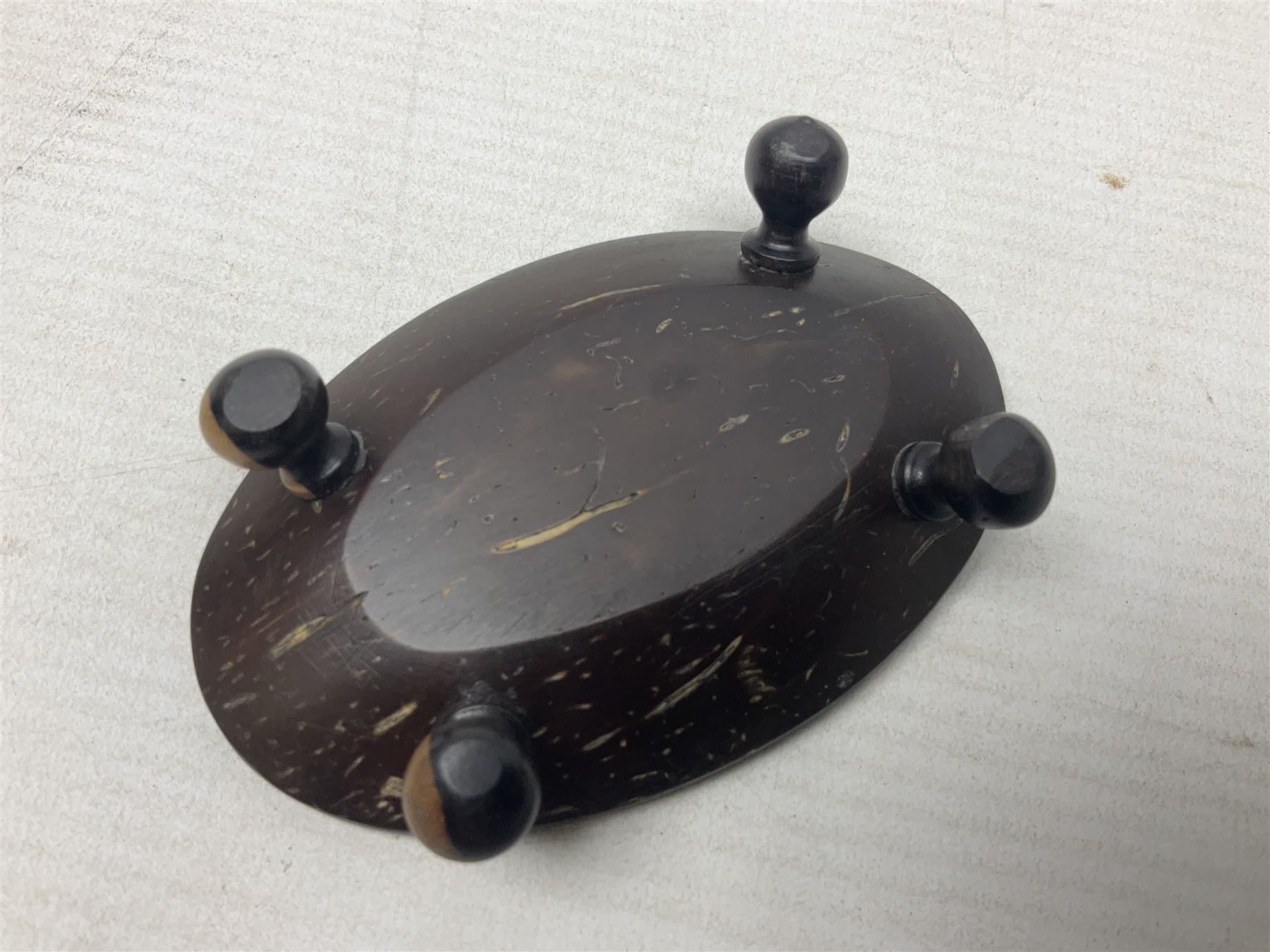 19th century bug bear flask carved with Balkan figures, a wolf and leafage with glass eyes, L14cm on stand 