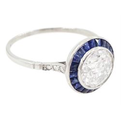 Platinum diamond and sapphire target ring, milgrain set single old cut diamond of 1.53 carat, with calibre cut sapphire surround and rose cut diamond set shoulders, stamped 950