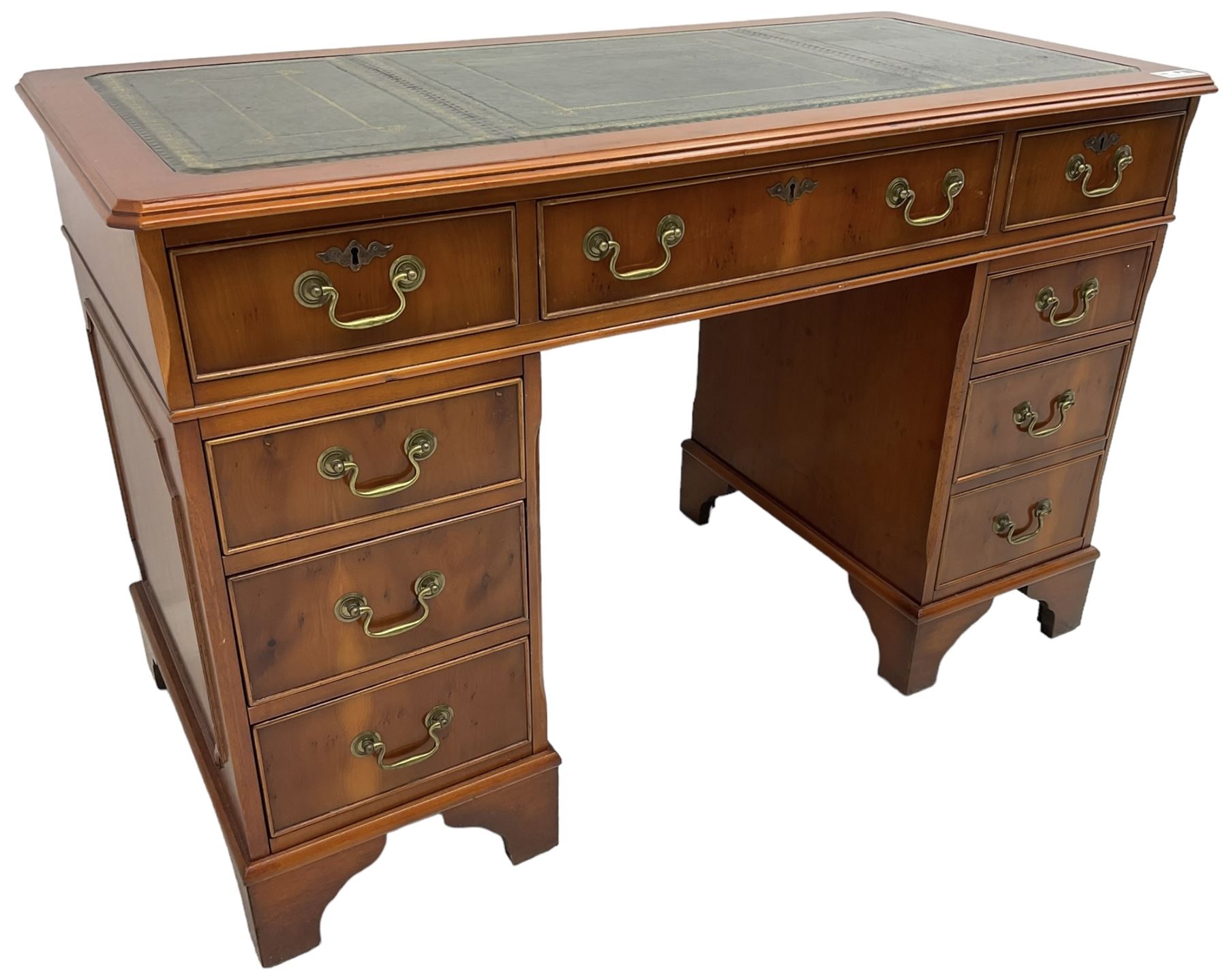 Georgian design yew wood twin pedestal desk, rectangular top with green leather inset writing surface, fitted with nine cock-beaded drawers, on bracket feet