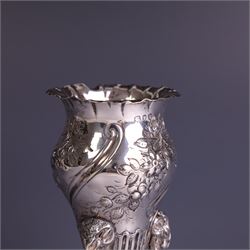 Late Victorian silver vase, of baluster form with fluted rim, the body with embossed floral decoration, upon three tall legs with ramshead mounts, hallmarked William Comyns & Sons, London 1890, H13.5cm