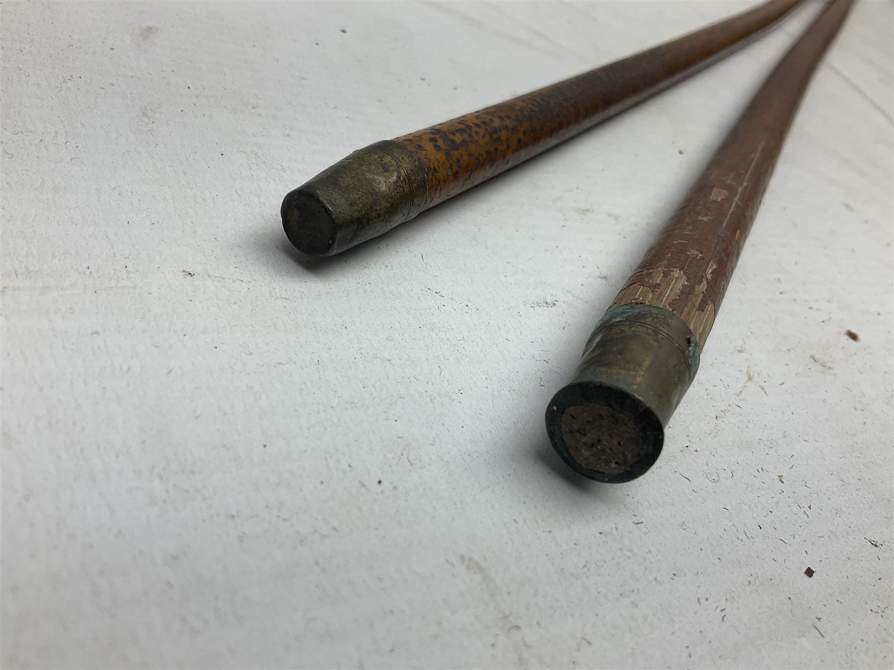 George V 1897 pattern Army Officer's sword by Henry Wilkinson Pall Mall London, the 82.5cm 'London Made' blade etched to both sides with Royal Crests and cyphers etc, pierced half-basket hilt with wire-bound fish skin grip and remains of leather knot strap; in leather covered field service scabbard L101cm overall; and two 14th Prince of Wales Own swagger sticks (3)