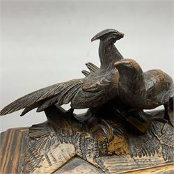 Carved wooden jewellery casket, the finial modelled as two grouse, each panel carved with flowers and leaves, opening to reveal compartmentalised interior, upon four feet, H26cm