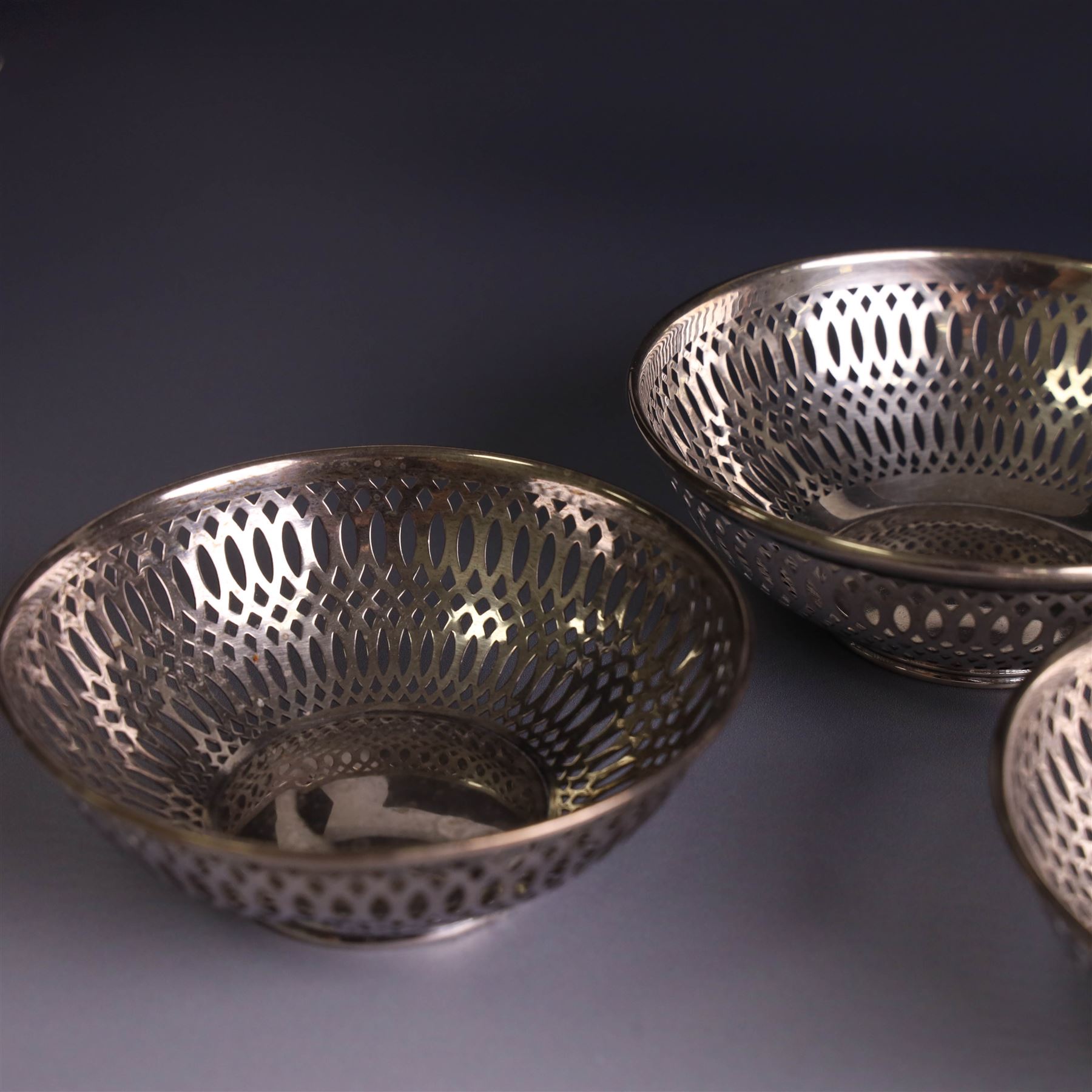 Three 1930s silver bon bon dishes, comprising pair and one larger example, each of circular form with pierced latticework sides, hallmarked Maxfield & Sons Ltd, Sheffield 1936, largest D12cm