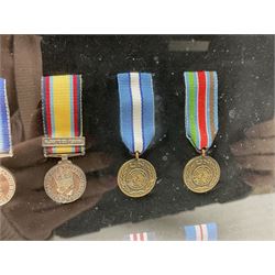 Limited edition large framed display board with sixty half-size copies of British Gallantry and Campaign Medals produced by Danbury Mint; all with ribbons and associated booklet