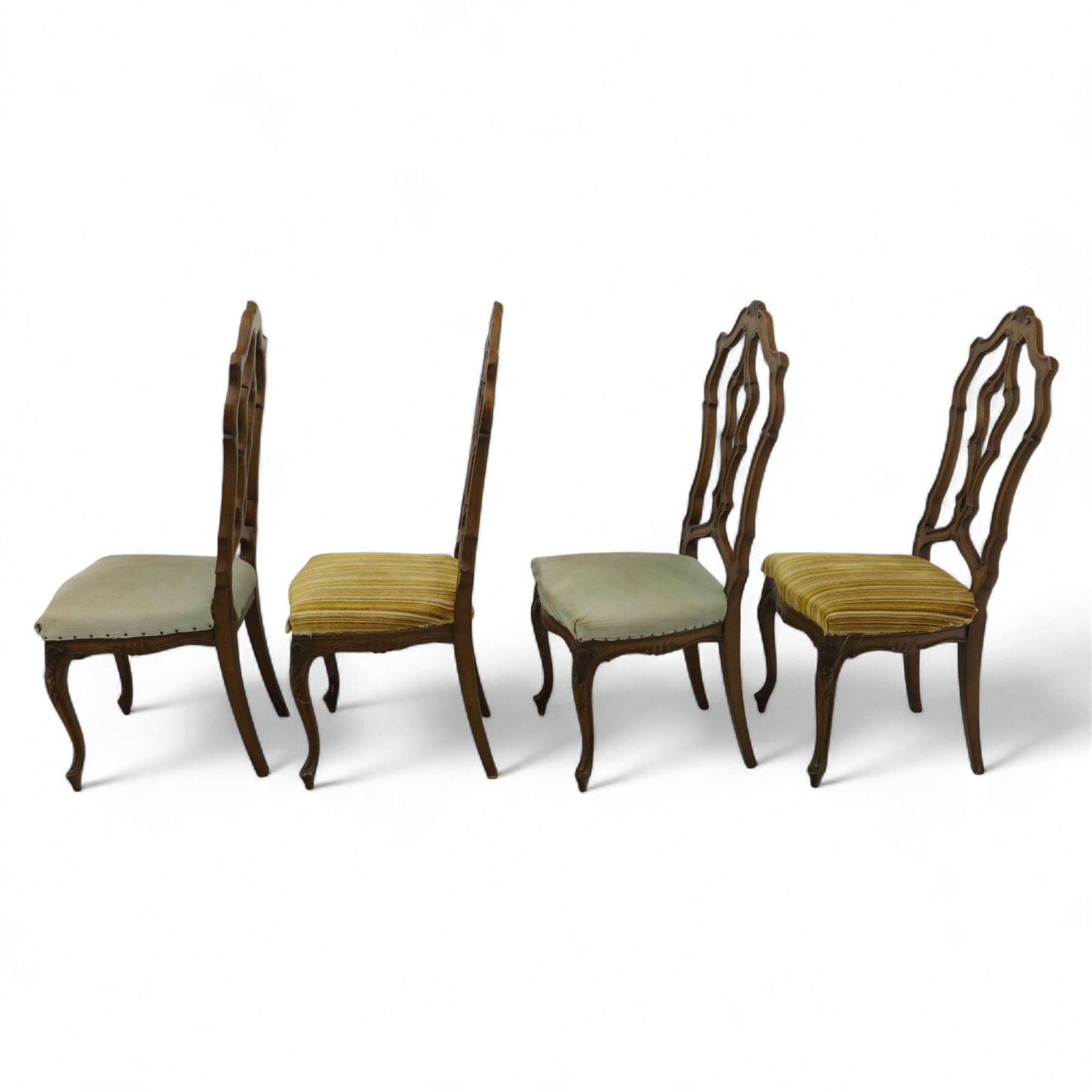 20th-century set of four French provincial-style stained beech dining chairs, pierced cartouche back with fan carving, with a scroll moulded frame above a padded serpentine seat on cabriole legs 