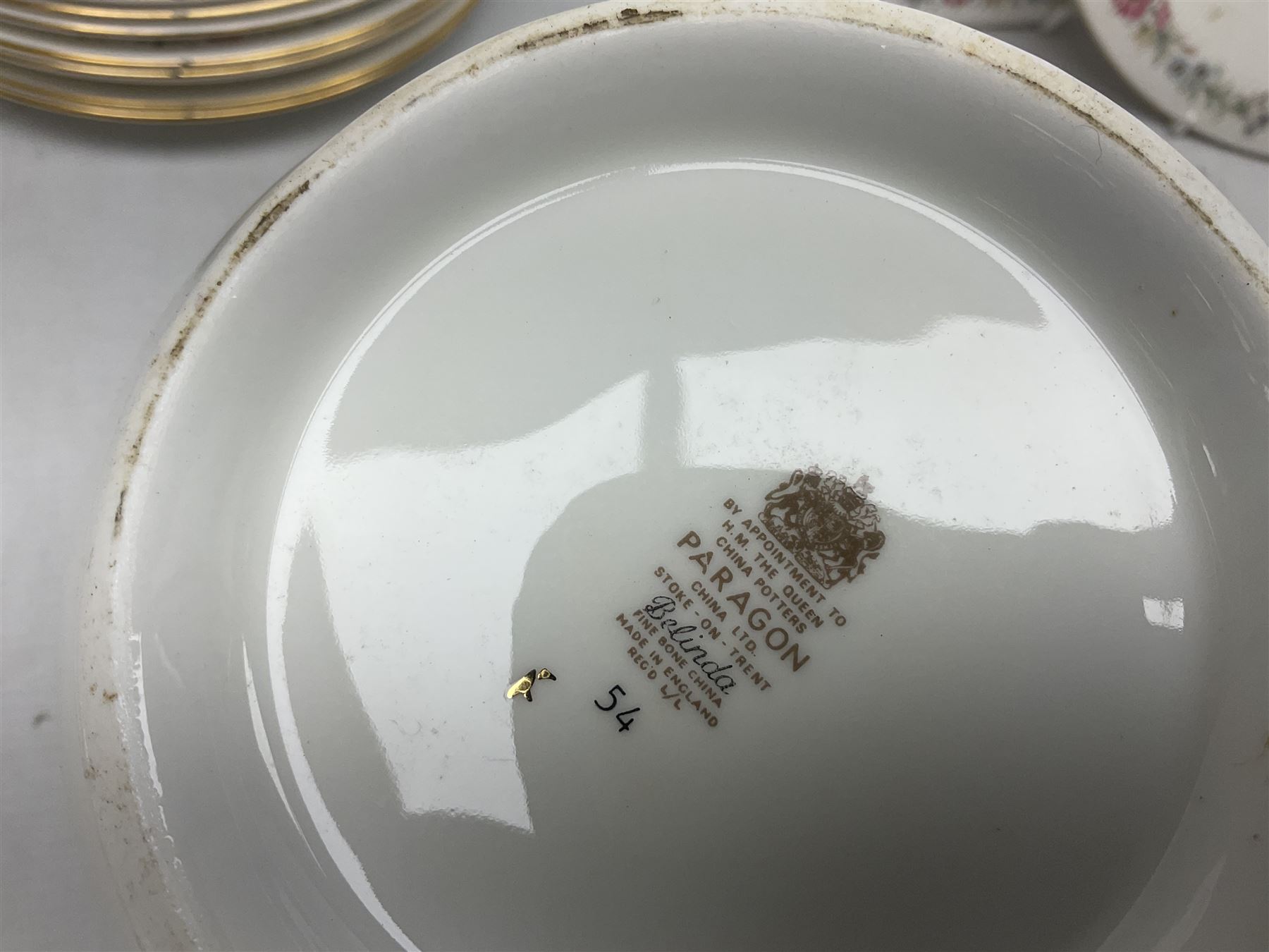 Royal Albert Paragon tea and dinner service for twelve decorated in the Belinda pattern, comprising fourteen saucers, twelve teacups, thirteen side plates, teapot, sauce boat and stand, salt and pepper shakers, two jugs, sucrier, twelve dinner plates, twelve smaller plates, two lidded tureens, twelve bowls, twelve smaller bowls, cake plate, oval plate and oval dish (100)