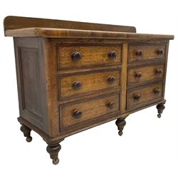 Victorian oak and sycamore dresser base, raised back over rectangular top with rounded front corners, fitted with six drawers with mahogany bandings and turned handles, on turned feet