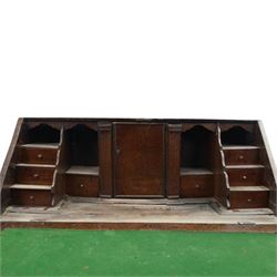 18th century inlaid oak bureau, the fall-front with central star inlay enclosing fitted interior with central cupboard flanked by fluted column correspondence drawers and pigeon holes, over two short and three long drawers, lower moulded edge on bracket feet