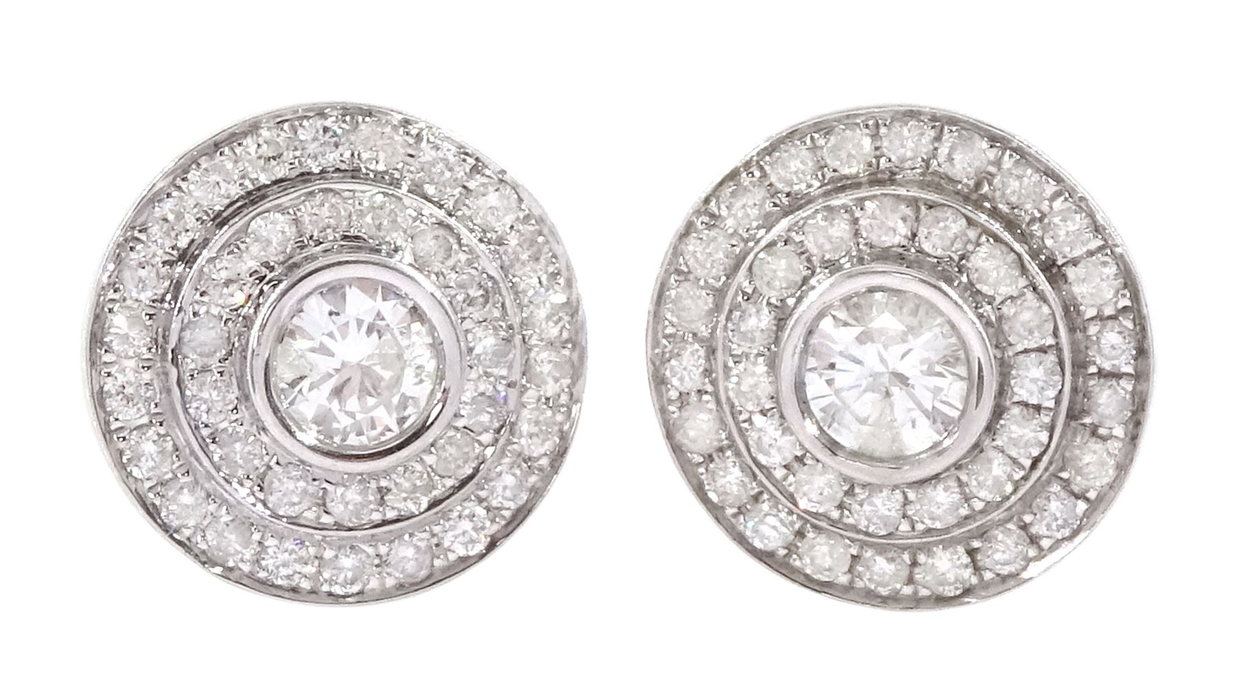 Pair of 18ct white gold round brilliant cut diamond halo stud earrings, the central bezel set diamonds with two row diamond surround, stamped, total diamond weight approx 1.20 carat