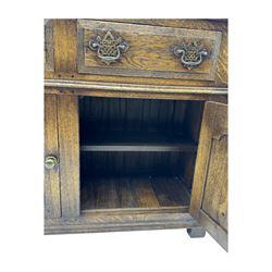 Early 20th century Jacobean design oak dresser sideboard, rectangular top with moulded edge over two baize-lined drawers with pierced handles, above two fielded panel cupboard doors, on stile supports
