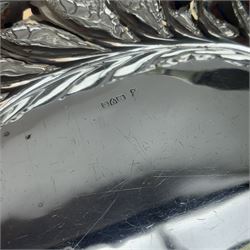 Edwardian silver swing handled basket, of oval form with shaped rim, embossed with floral decoration and with pierced latticework sides, upon four pad feet, hallmarked Chester 1905, maker's mark worn and indistinct