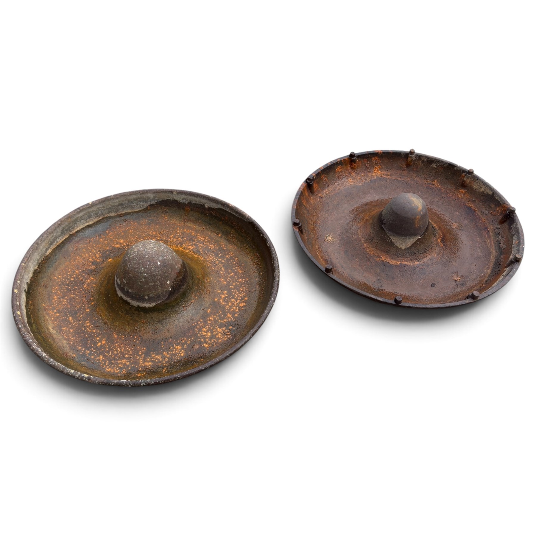 Two early 20th century cast iron ‘Mexican hat’ pig trough planters, each of circular dished form with central domed boss, one fitted with fixing studs for radial feeding divisions