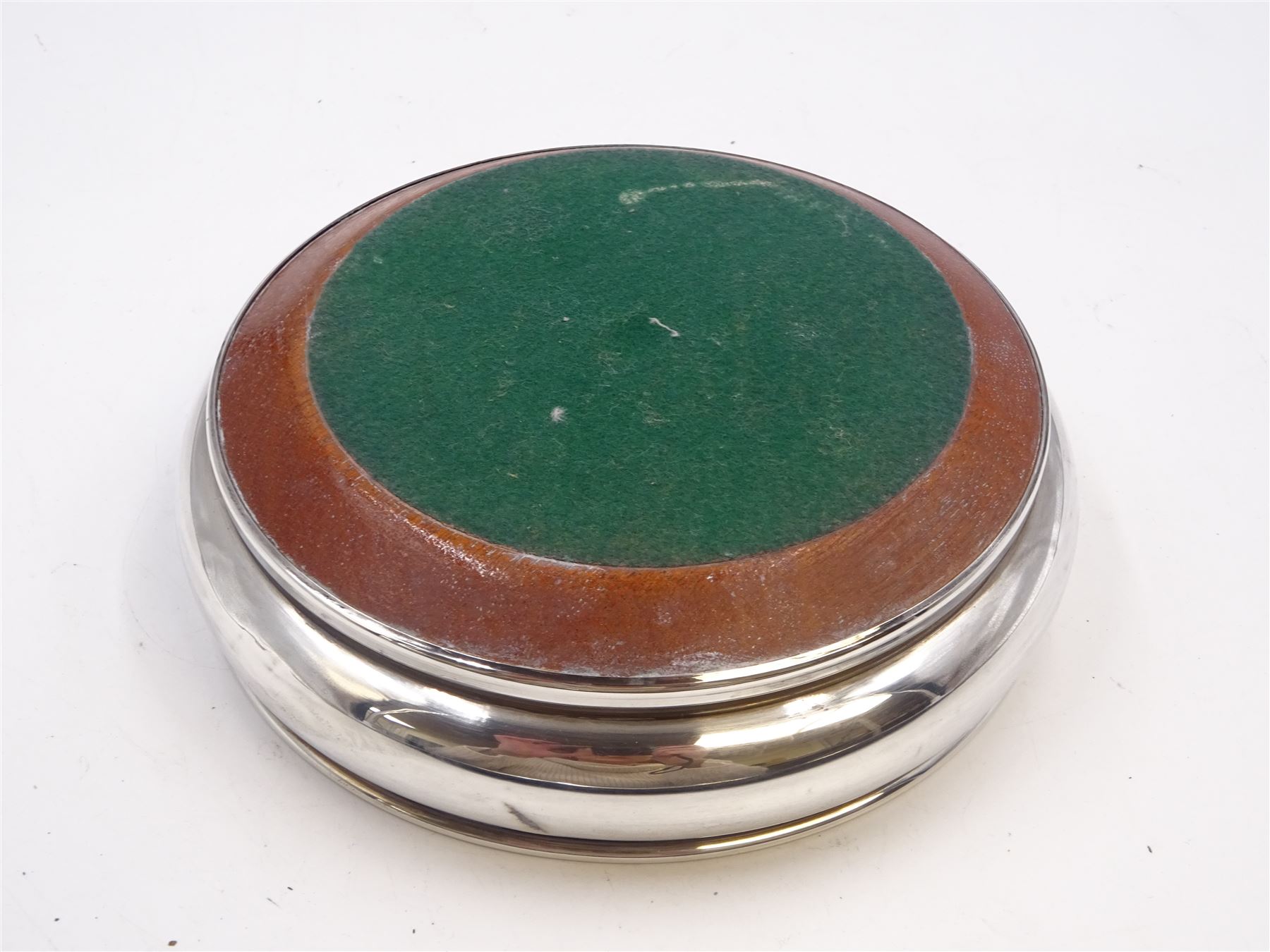 Modern silver mounted bottle coaster, of plain circular form with turned mahogany centre, hallmarked W I Broadway & Co, Birmingham 1979, D13cm