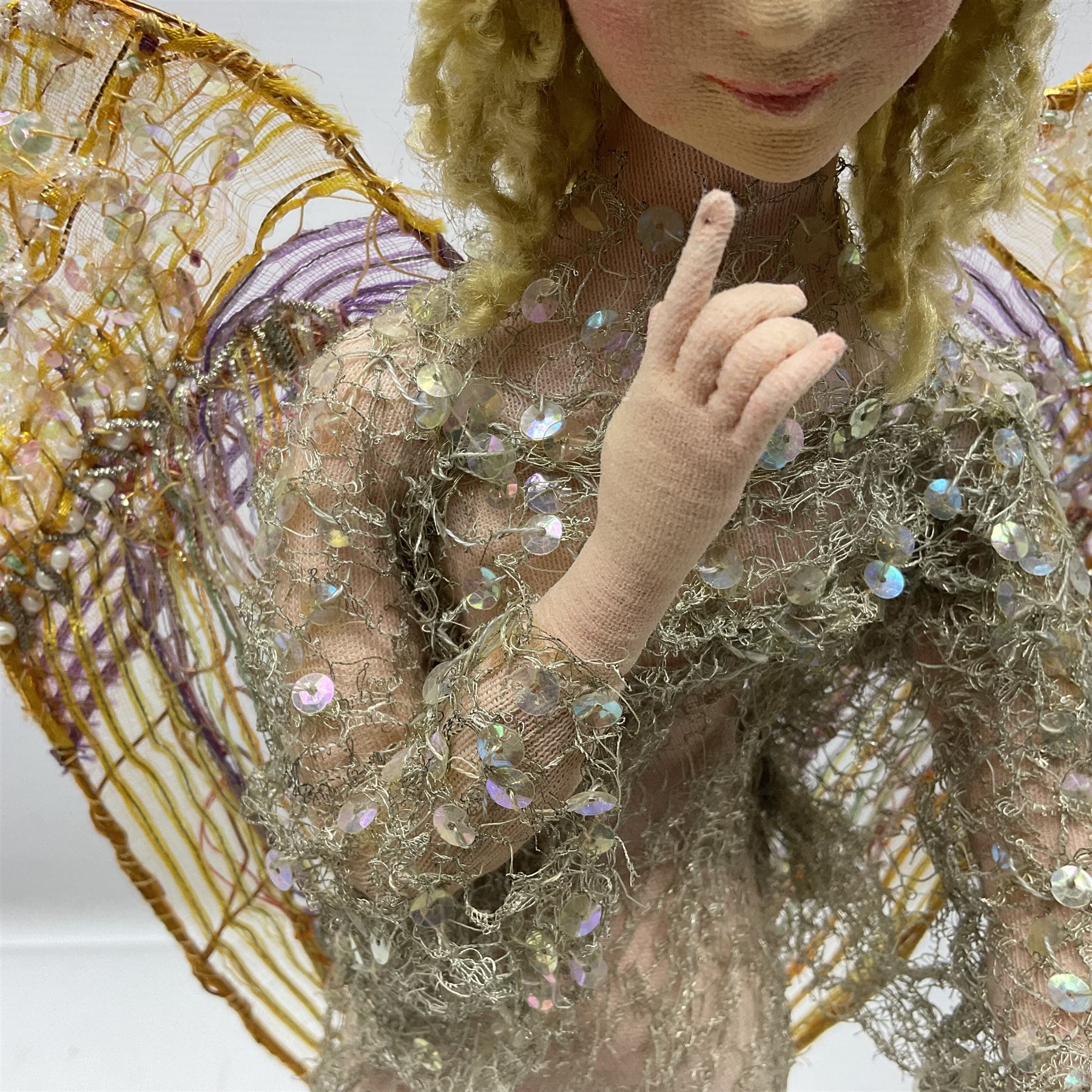 Anna Meszaros Hungary - hand made needlework figurine of an Angel with metallic lace full length dress and open threadwork wings; on moulded base H45cm Auctioneer's Note: Anna Meszaros came to England from her native Hungary in 1959 to marry an English businessman she met while demonstrating her art at the 1958 Brussels Exhibition. Shortly before she left for England she was awarded the title of Folk Artist Master by the Hungarian Government. Anna was a gifted painter of mainly portraits and sculptress before starting to make her figurines which are completely hand made and unique, each with a character and expression of its own. The hands, feet and face are sculptured by layering the material and pulling the features into place with needle and thread. She died in Hull in 1998.