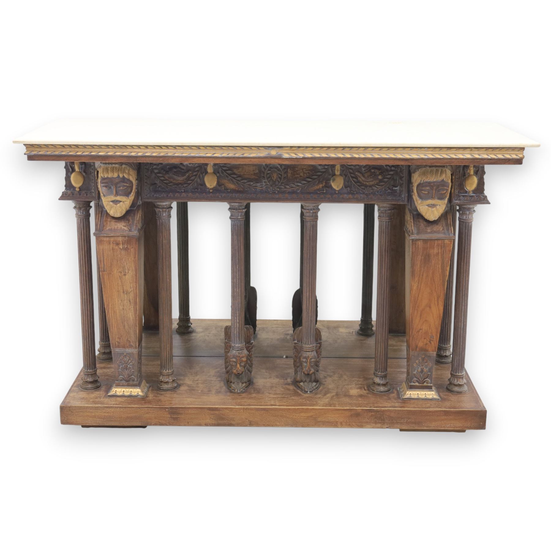 20th century carved hardwood console table in Renaissance taste, moulded marble slab top over a frieze decorated with festoons and roundels, the angles carved with grotesque mask brackets, supported by six fluted columns with carved mask and paw feet terminals, on a stepped plinth base with mirrored back