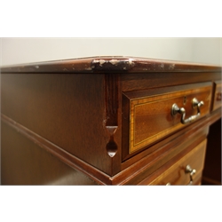  Reproduction mahogany twin pedestal desk, canted rectangular top with leather inset and banded in satinwood, eight drawers, on plinth base, W138cm, H78cm, D77cm  