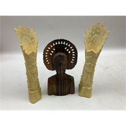 Hardwood bust of an Indoniesian Goddess, carved wearing a pierced headdress, from Klungkung, Bali, H20cm, together with a pair of bone carvings of deity figures, and a carved wood Netsuke in the form of a Chinese dragon