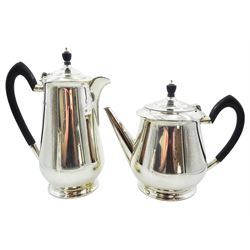 1940's silver four piece tea service, comprising teapot, hot water pot, milk jug, and twin handled open sucrier, each of plain footed form, the teapot and hot water pot with curved ebonised handles and ebonised finials, hallmarked James Dixon & Sons Ltd, Sheffield 1940, approximate gross weight 57.29 (1782 grams)
