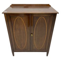 Edwardian mahogany cupboard, rectangular moulded top with raised back and satinwood band, enclosed by two panelled doors with oval satinwood inlays, two internal shelves, on square tapering feet