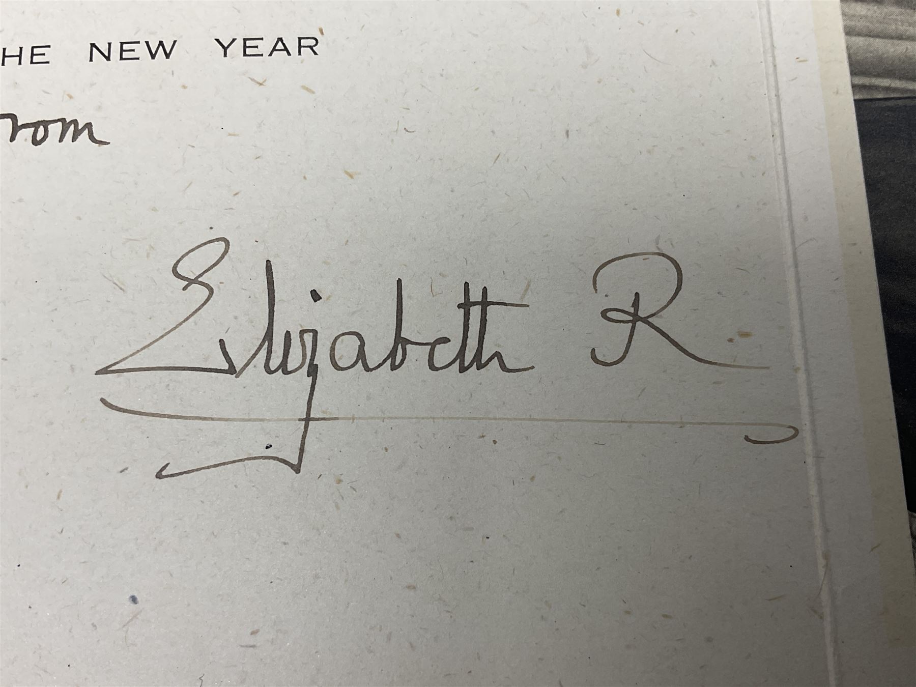 King George VI and Queen Elizabeth - signed 1945 Christmas card with gilt embossed crown to cover, black and white photograph to the interior, of The Royal Family waving from the balcony of Buckingham Palace, on V-E Day Tuesday May 8th 1945, signed 'George R.I. Elizabeth R.'