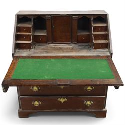 18th century inlaid oak bureau, the fall-front with central star inlay enclosing fitted interior with central cupboard flanked by fluted column correspondence drawers and pigeon holes, over two short and three long drawers, lower moulded edge on bracket feet