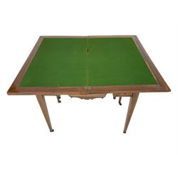 Edwardian inlaid mahogany games or work table, rectangular fold-over top inlaid with stylised dragon ivorine decoration and stringing, fitted with one long flanked by four small drawers over sewing compartment drawer, raised on square tapering supports with castors