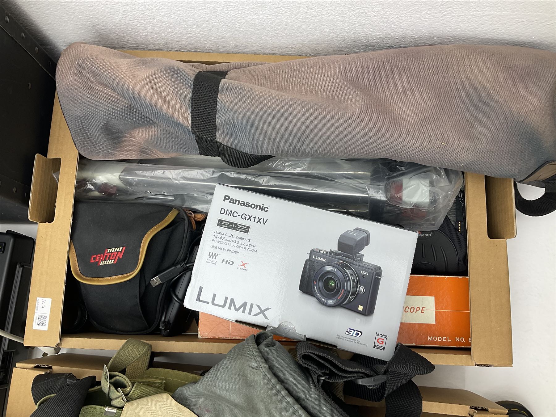 Large quantity of camera equipment in three boxes - Lumix GX1 camera, Canon EOS 500 camera, Lumix FZ100 camera, Pantax  MZ5n, various other cameras, Swift spotting Scope 20 x 60 in box,  Maxtor hard drive, three tripods, Kodak carousel projector, Pradolux slide projector, a selection of camera bags and other camera equipment. 
