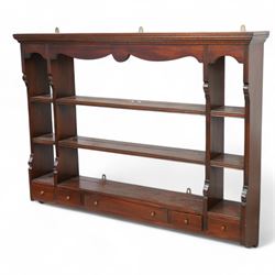 Georgian design mahogany wall rack, moulded cornice over shaped frieze and thee shelves, fitted with five drawers
