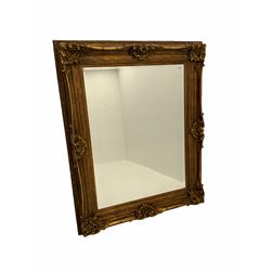 Large rectangular wall mirror in heavy swept gilt frame, bevelled glass