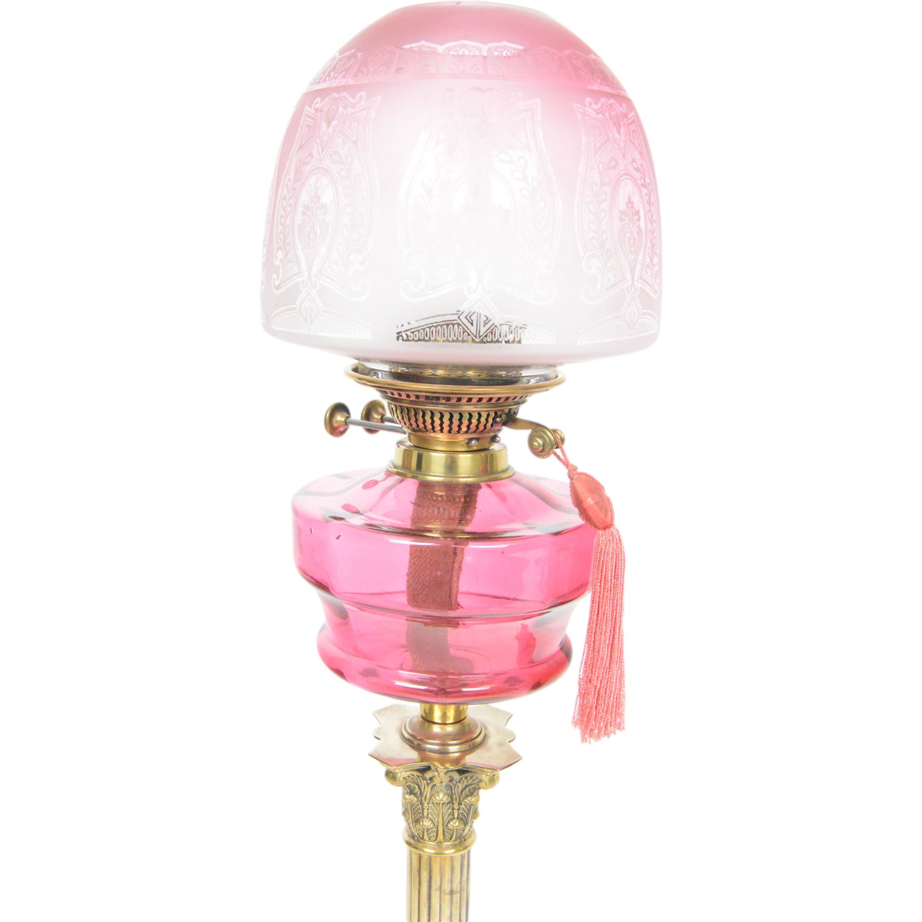 Victorian brass oil lamp, the Corinthian column supporting a cranberry glass burner and opaque etched cranberry glass shade and clear glass chimney, overall H77cm