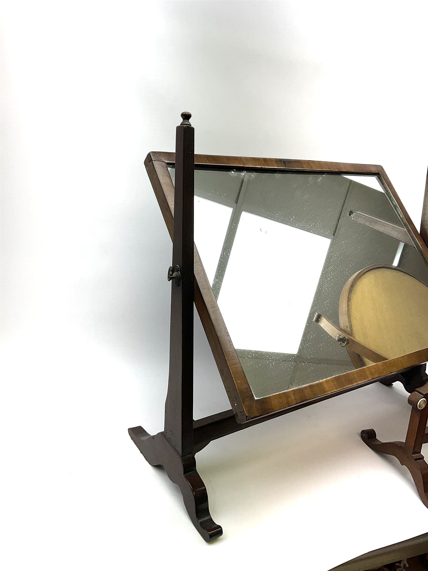 An Edwardian mahogany dressing table mirror, the oval mirror plate in swing frame, upon flared legs linked by stretcher, the frame detailed with turned roundels, H49cm, together with a Victorian mahogany example, H50cm. 