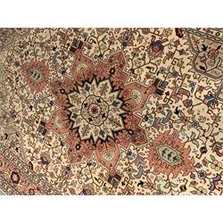 Fine Persian Tabriz rug, ivory and peach ground, central medallion surround by interlacing geometric foliage an decorated with stylised flower heads, repeating boarder with guards 