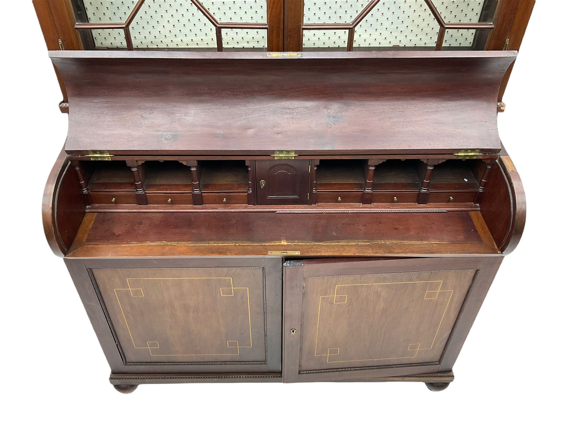 19th century mahogany piano top secretaire bookcase, two astragal doors above curved hinged retractable writing compartment, above two cupboards