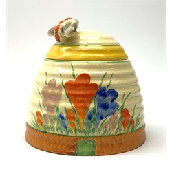 A Clarice Cliff Newport Pottery honey pot, modelled in the form of a beehive and decorated in the Crocus pattern, H10cm.