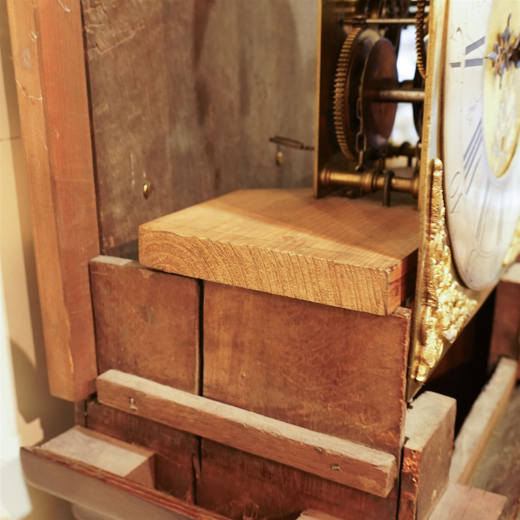 Jonas Barber of Winster (Westmoreland), provincial mid-18th century ash and oak cased 30-hour longcase clock, hood with a flat pediment, square hood door and attached pilasters, trunk with a full length shaped door on a square plinth with an applied skirt, brass dial with cast cherub spandrels, plain dial centre with date aperture and steel hands, silvered chapter ring engraved with Roman numerals, five minute Arabic's, quarter hour and minute tracks with half-hour markers, chain driven countwheel striking movement striking the hours on a bell. With weight and pendulum.
