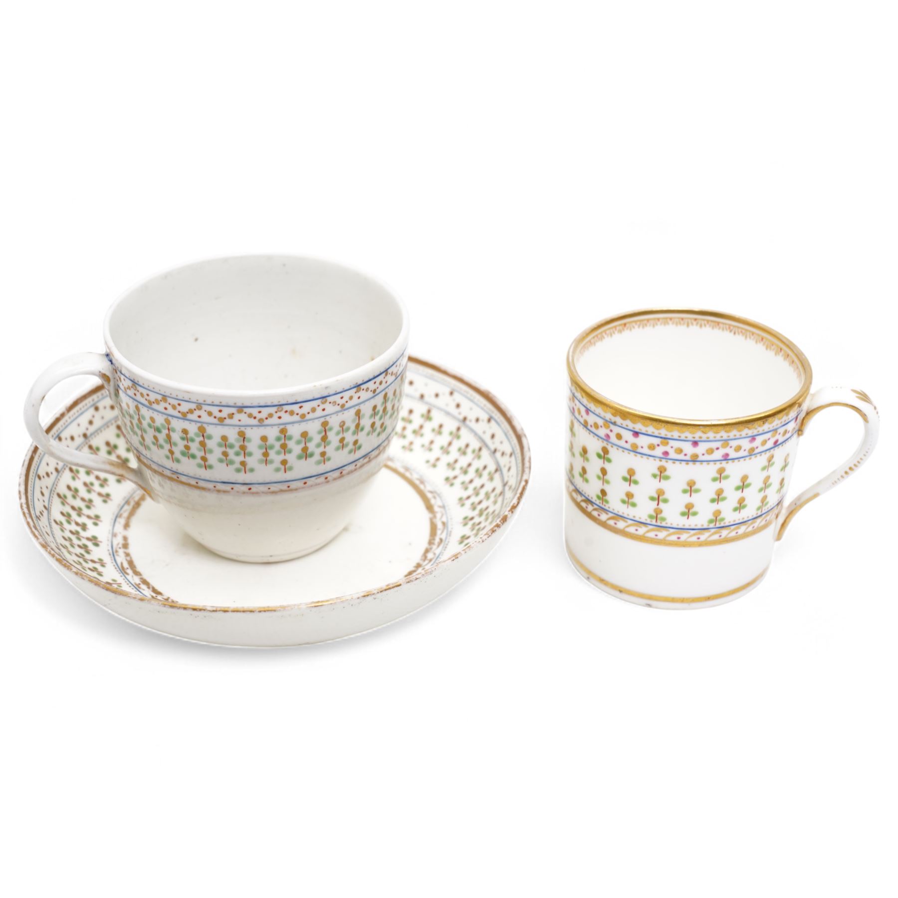 Pinxton porcelain trio, pattern no.193, comprising coffee can, teacup and saucer, decorated with green and gilt stylised sprigs and red and gilt dot borders, teacup with painted marks to base (3)