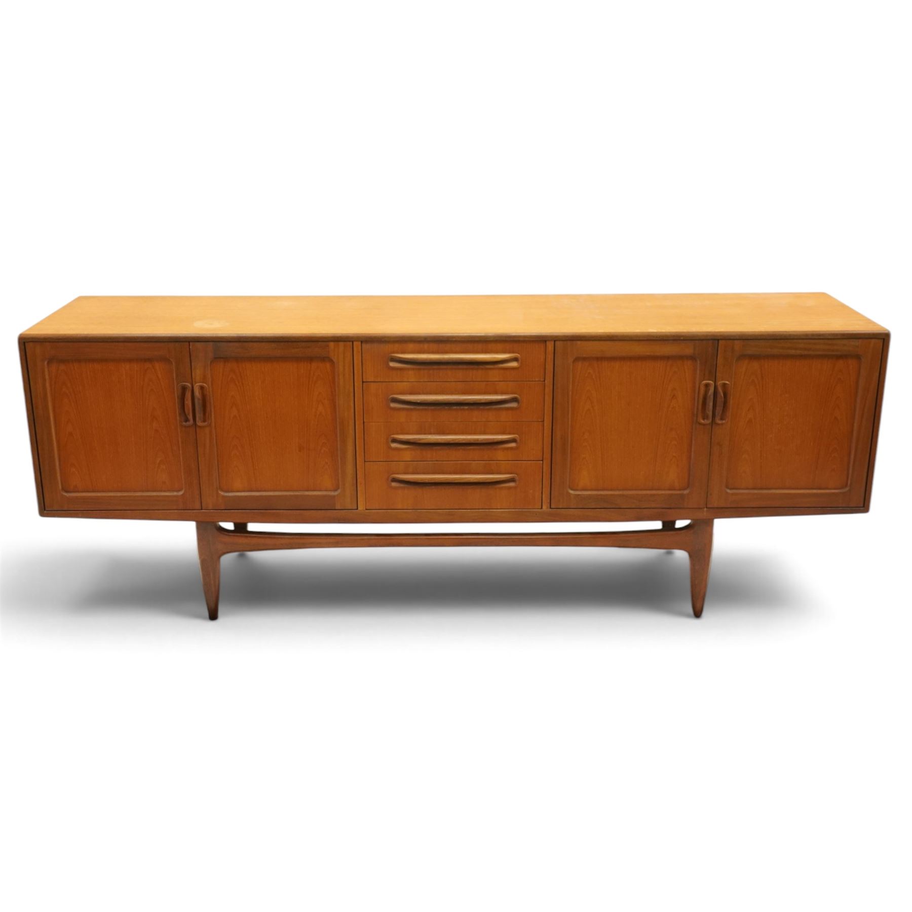 G-Plan - 'Fresco Long John' teak mid 20th century sideboard, a central bank of four drawers, flanked by twin cupboard doors, with recessed handles, on a tapering supports 