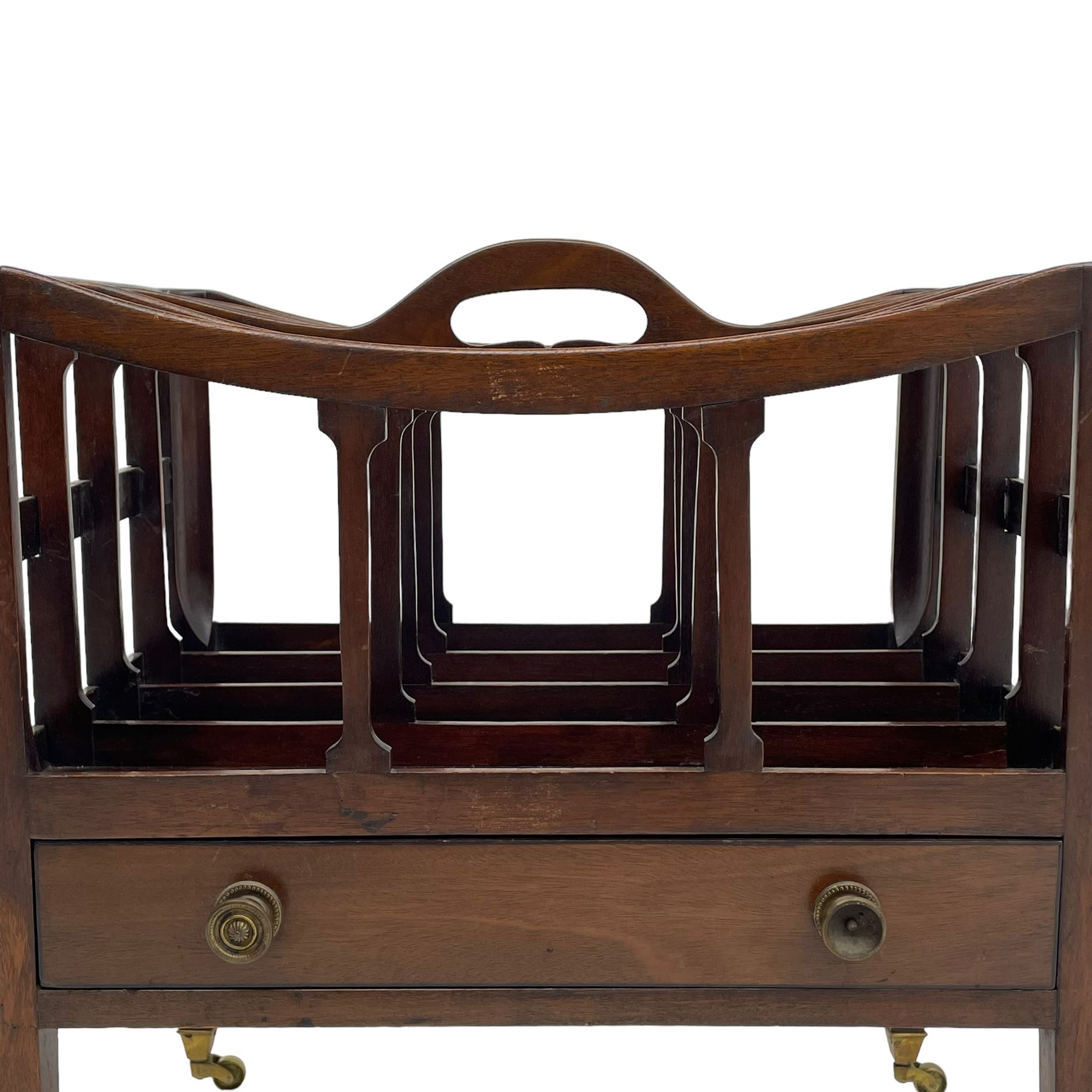 Georgian design mahogany Canterbury, four divisions with dished upper rails, the central rail pierced with handle, fitted with single drawer, on square supports with brass cups and castors 
