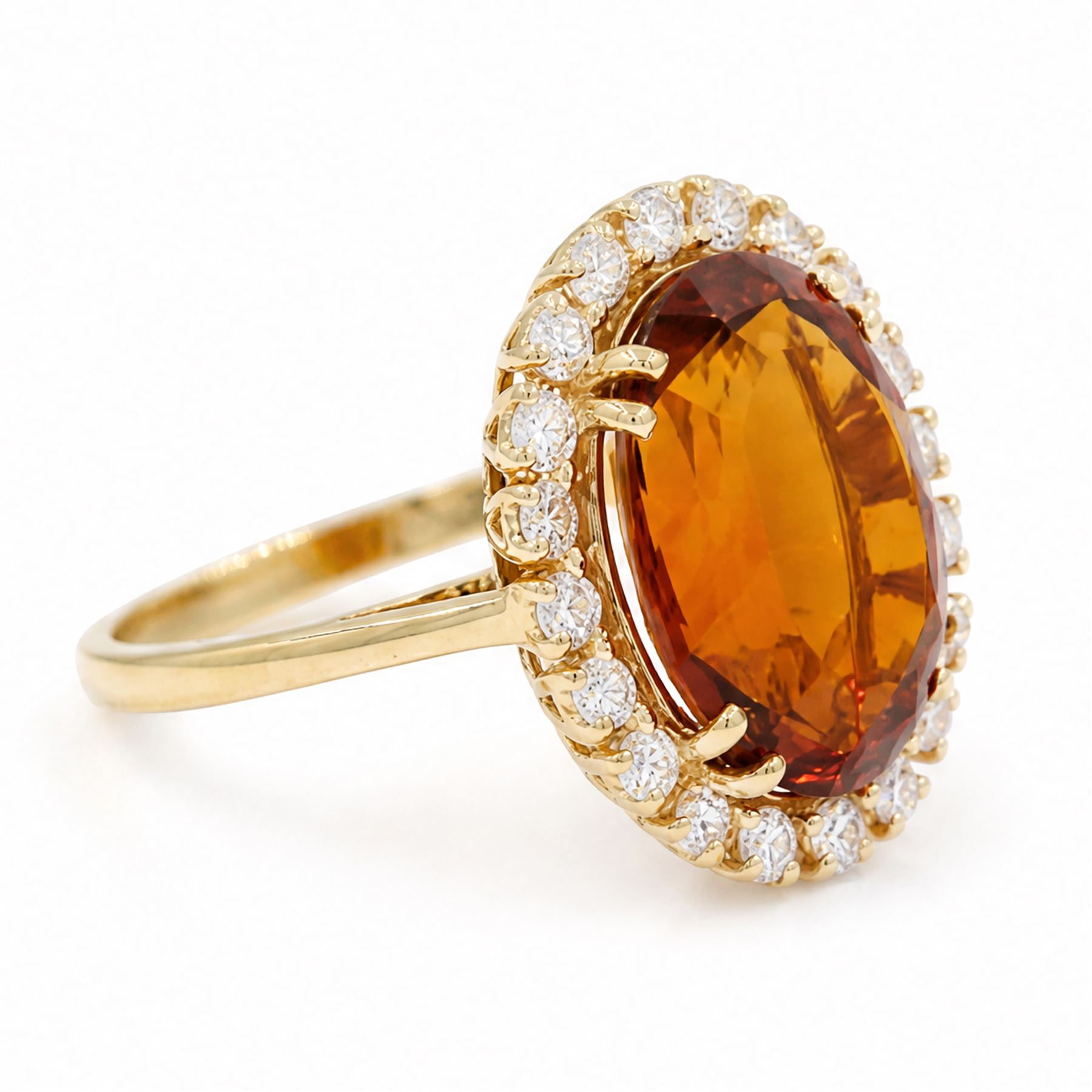 18ct gold citrine and diamond cluster ring, single oval cut citrine of approx 6.90 carat, surrounded by twenty round brilliant cut diamonds, stamped, total diamond weight approx 0.60 carat