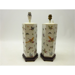  Pair Chinese Famille Rose hexagonal table lamps each decorated with butterflies on hardwood stands, H29cm   