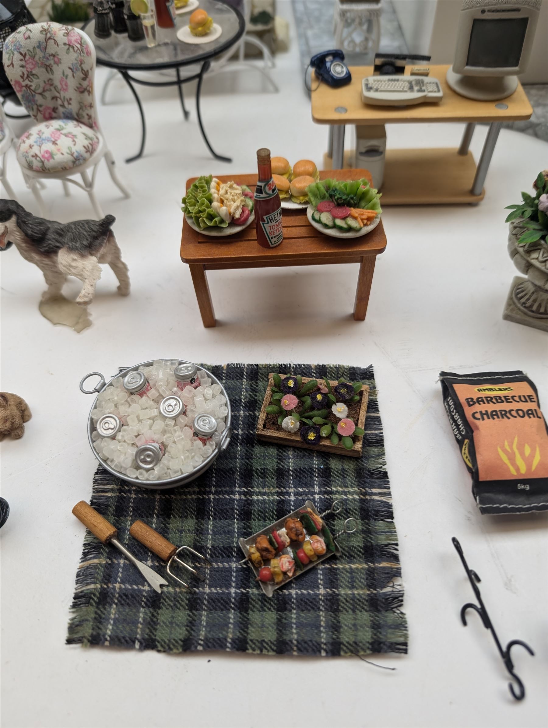 1:12 scale dolls house conservatory and garden accessories, including white wooden glazed conservatory on a stone effect base, black and white metal garden seating, barbecue, plant shelves, parasol, barbeque accessories, large planters, rabbit hutch, animals, chimenea, etc