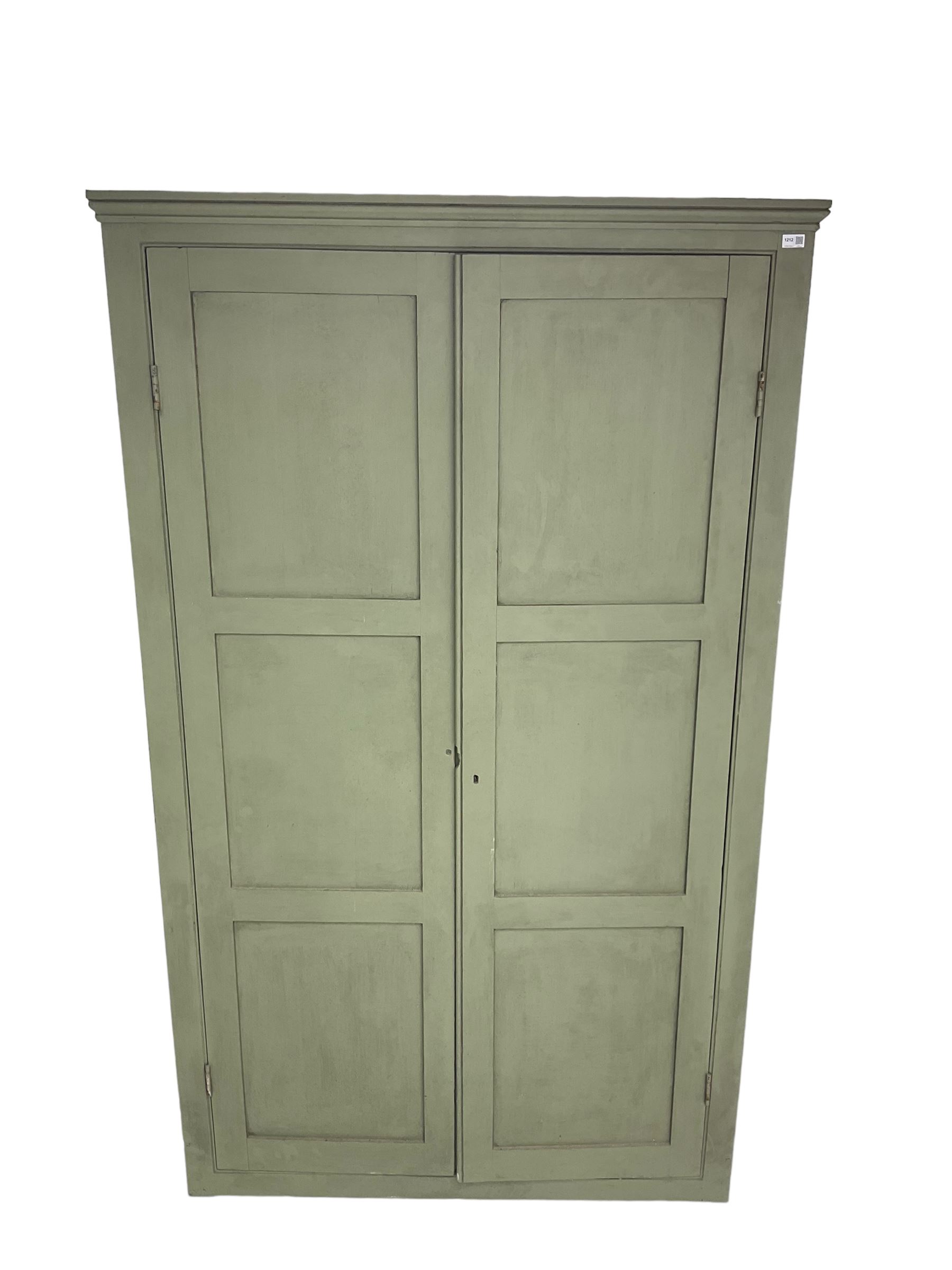 Painted pine cupboard, two panelled doors enclosing four shelves, in laurel green finish