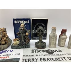 Terry Pratchett Discworld figures, designed by Clarecraft, comprising Cohen the barbarian, DW42, the Patrician, boxed, DW37, three Potions, DW18, DW19, DW20, two Death Bookstamps, DW50, the Gods Dice Box, boxed, DW26, together with two Discworld newsletters, volume 5, August 1998 and volume 6, August 1999. 