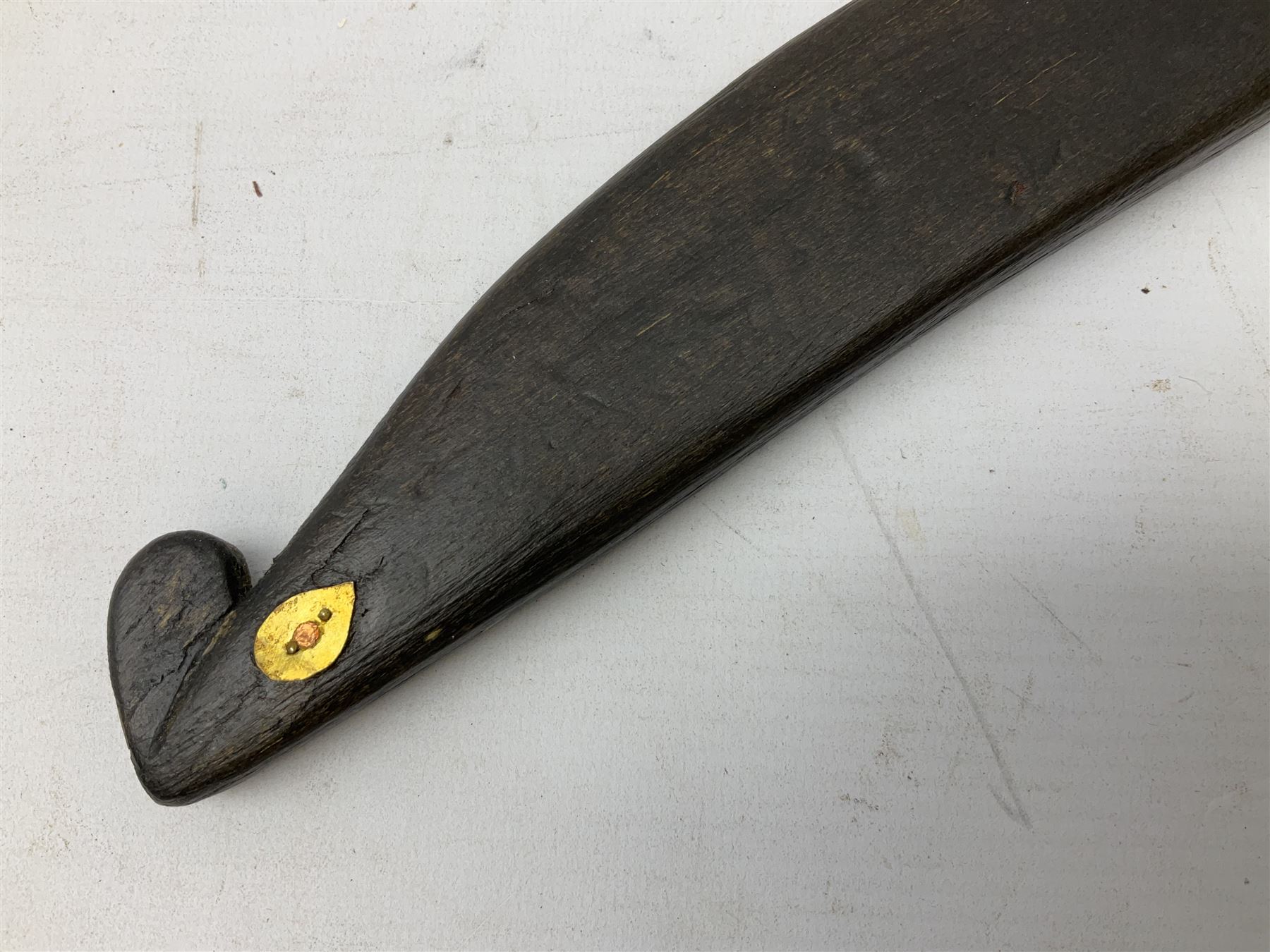 19th century Singhalese knife pia kaetta, the 20cm steel blade inset with yellow and white metal, with metal mounted carved pistol grip, in plain wooden scabbard L33cm overall
