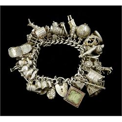 Silver charm bracelet, charms including dachshund, trophy football, spiders web, cheque book, bunny, poodle, 21 key, shoe house, bagpiper, horse and carriage and cat in a bin