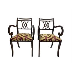 Regency design mahogany twin pedestal dining table, rectangular top with reeded edge, acanthus carved turned column terminating in reeded tripod base with hairy paw feet and castors (W172cm D92cm H75cm) and set eight (6+2) Regency design mahogany dining chairs, pierced back with scroll design, seat upholstered in patterned laurel green fabric, raised on reeded sabre supports (W48cm H88cm)