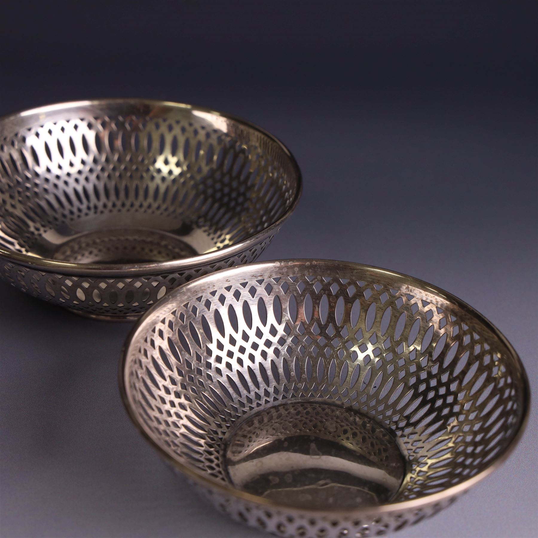 Three 1930s silver bon bon dishes, comprising pair and one larger example, each of circular form with pierced latticework sides, hallmarked Maxfield & Sons Ltd, Sheffield 1936, largest D12cm