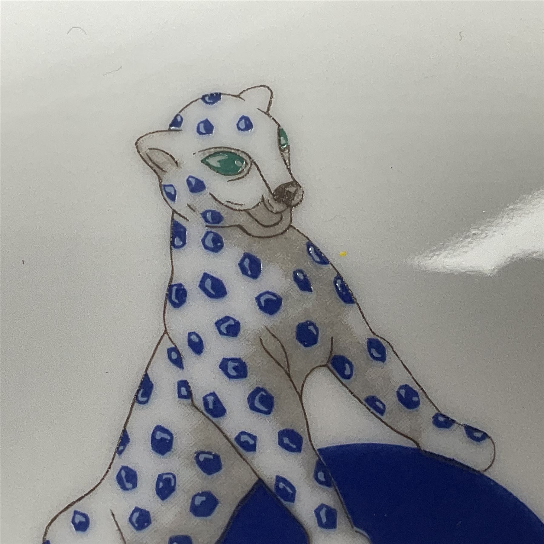 Limoges for Cartier, ceramic trinket dish, of rectangular form with rounded corners, decorated to centre with leopard upon a blue ball, with blue and gilt rim, with printed mark beneath, in original box, H15.5cm, W21cm