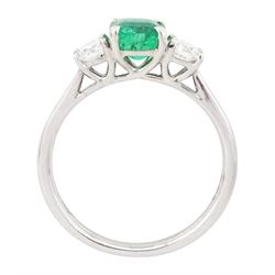 18ct white gold emerald and diamond three stone ring, single modified square cut emerald of approx 0.65 carat, with a round brilliant cut diamond set either side, hallmarked, total diamond weight approx 0.35 carat