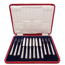 Early 20th century set of silver handled fruit knives and forks for six place settings, each with tapering canted handle, hallmarked Thomas Bradbury & Sons Ltd, Sheffield 1917, contained within a fitted case